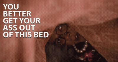 A Woman With Glasses And A Pearl Necklace Is Hiding Under A Blanket With The Words You Better Get Your Ass Out GIF
