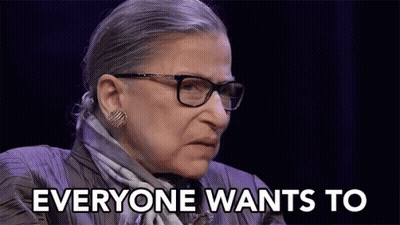 A Woman With Glasses And A Scarf Is Saying Everyone Wants To GIF