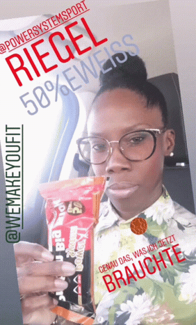 A Woman With Glasses Is Holding A Bag Of Riegel 50 % Eweiss GIF