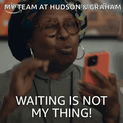 A Woman With Glasses Is Holding A Cell Phone And Says Waiting Is Not My Thing . GIF