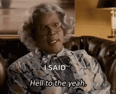 A Woman With Glasses Is Sitting On A Couch And Saying `` I Said Hell To The Yeah '' . GIF