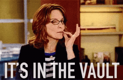A Woman With Glasses Is Smoking A Cigarette And The Words It 'S In The Vault Are Behind Her GIF