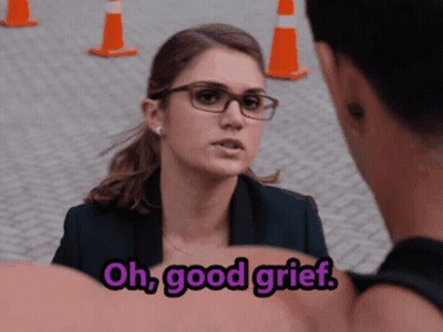 A Woman With Glasses Is Talking To A Man With The Words Oh Good Grief Above Her GIF