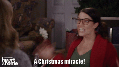 A Woman With Glasses Says A Christmas Miracle In A Super Channel Ad GIF