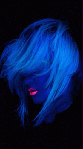 A Woman With Glow In The Dark Hair And Pink Lips GIF