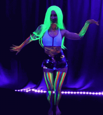 A Woman With Glow In The Dark Paint On Her Body Dancing GIF