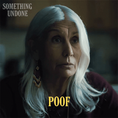 A Woman With Gray Hair Has The Word Poof Above Her Head GIF