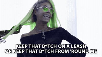 A Woman With Green Hair And Sunglasses Says Keep That B * Tch On A Leash Or Keep That B * Tch From ' Round Me GIF