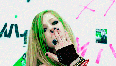 A Woman With Green Hair Is Blowing A Kiss With Her Hand GIF
