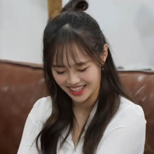 A Woman With Half Of Her Hair In A Bun Smiles GIF