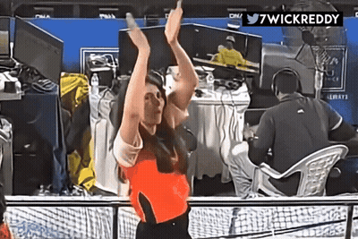 A Woman With Her Arms In The Air Is Dancing In Front Of A Twitter Logo That Says 7Wickreddy GIF