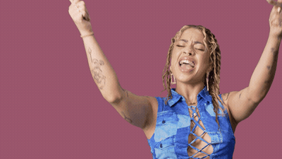 A Woman With Her Arms In The Air With Yas Queen Written On The Bottom GIF