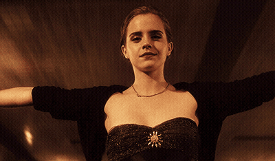 A Woman With Her Arms Outstretched Wearing A Black Top GIF