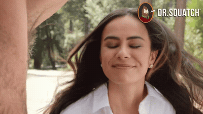 A Woman With Her Eyes Closed And A Dr.squatch Logo On The Bottom GIF