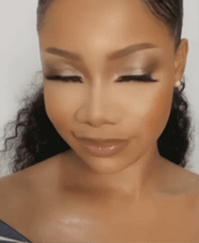 A Woman With Her Eyes Closed And Her Hair In A Ponytail . GIF