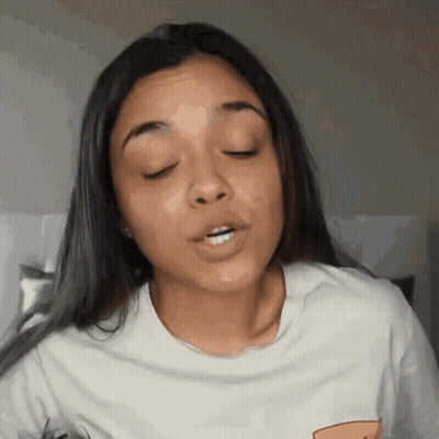 A Woman With Her Eyes Closed And Her Mouth Open GIF