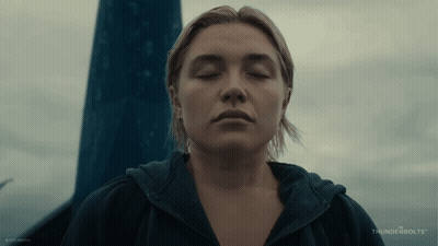 A Woman With Her Eyes Closed And The Word Thunderbolts On The Bottom Right GIF