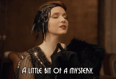 A Woman With Her Eyes Closed And The Words A Little Bit Of A Mystery GIF