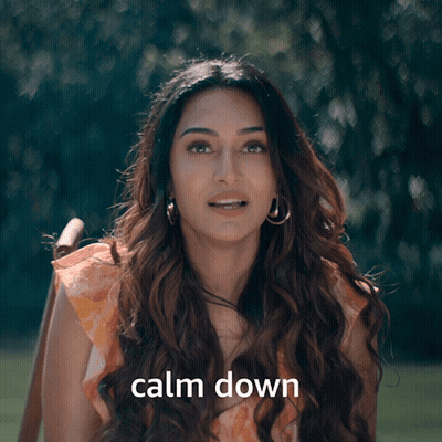 A Woman With Her Eyes Closed And The Words Calm Down Behind Her GIF