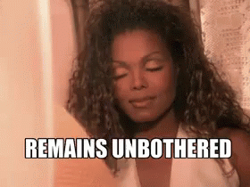 A Woman With Her Eyes Closed And The Words `` Remains Unbothered '' Written On Her Face . GIF