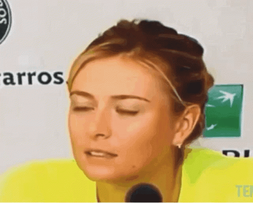 A Woman With Her Eyes Closed Is Standing In Front Of A Sign That Says Carros GIF