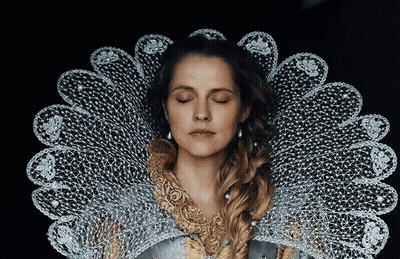 A Woman With Her Eyes Closed Is Wearing A Lace Collar Around Her Neck GIF