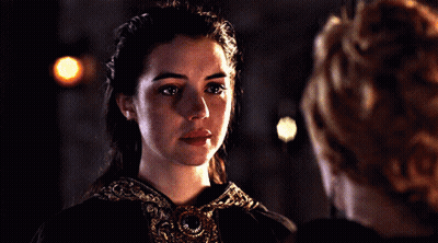 A Woman With Her Eyes Closed Looks Down At Something GIF