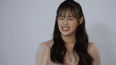 A Woman With Her Eyes Closed Making A Funny Face GIF