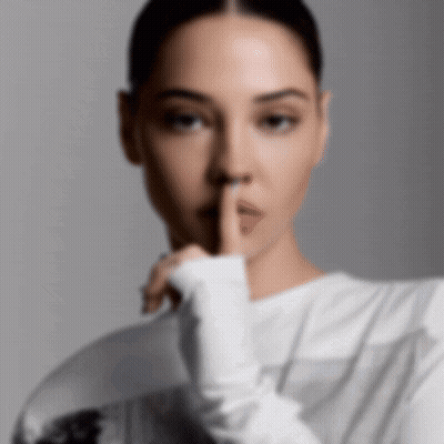 A Woman With Her Finger To Her Mouth GIF