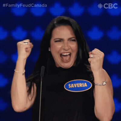A Woman With Her Fist In The Air Has A Name Tag That Says Saveria GIF