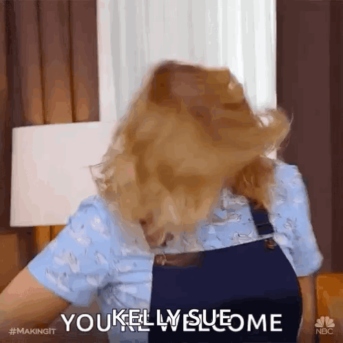 A Woman With Her Hair Blowing In The Wind Is Saying You Kelly Sueome GIF