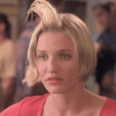 A Woman With Her Hair In A Mohawk And A Red Shirt . GIF