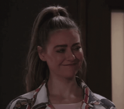 A Woman With Her Hair In A Ponytail Is Making A Silly Face GIF