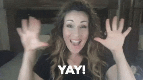 A Woman With Her Hands In The Air And The Word Yay Behind Her GIF