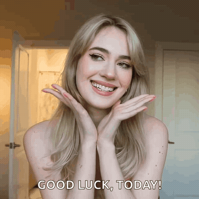 A Woman With Her Hands On Her Face Is Smiling And Says " Good Luck Today " GIF