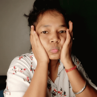 A Woman With Her Hands On Her Face Is Wearing A Red Bracelet GIF