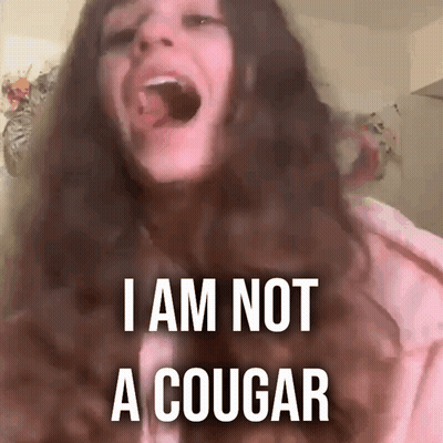 A Woman With Her Mouth Open And The Words I Am Not A Cougar Above Her GIF