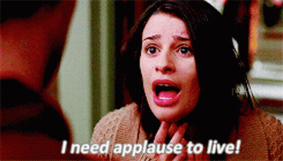 A Woman With Her Mouth Open And The Words I Need Applause To Live GIF