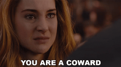 A Woman With Her Mouth Open And The Words " You Are A Coward " Behind Her GIF