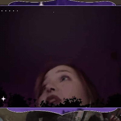 A Woman With Her Mouth Open In A Dark Room GIF