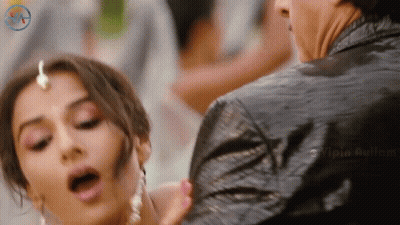 A Woman With Her Mouth Open Is Being Held By A Man In A Black Jacket With A Watermark That Says Vipia Aulum GIF