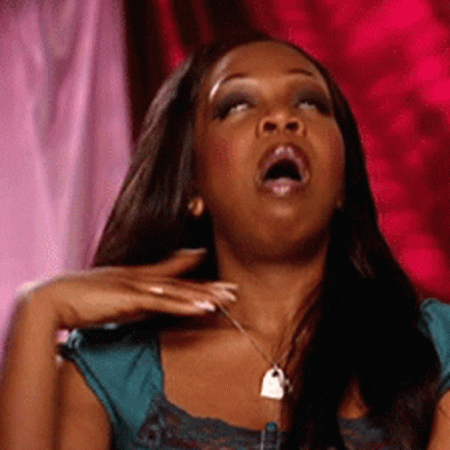 A Woman With Her Mouth Open Wearing A Blue Top GIF