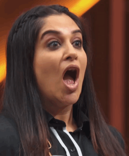 A Woman With Her Mouth Wide Open Making A Funny Face GIF
