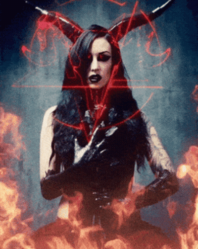 A Woman With Horns And Gloves Is Surrounded By Fire GIF