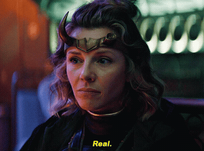 A Woman With Horns On Her Head Is Wearing A Black Shirt With The Word Real On It GIF