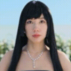 A Woman With Long Black Hair And A Pearl Necklace Is Wearing A Wig . GIF