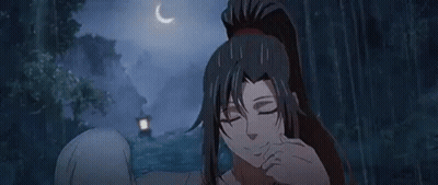 A Woman With Long Black Hair And A Ponytail Is Standing In A Forest . GIF
