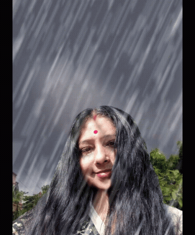 A Woman With Long Black Hair And A Red Dot On Her Forehead Smiles In The Rain GIF