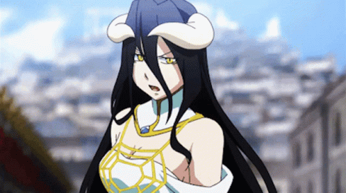 A Woman With Long Black Hair And Horns Is Standing In Front Of Buildings GIF
