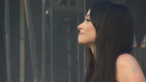 A Woman With Long Black Hair Has A Tattoo On Her Shoulder That Says ' A ' On It GIF